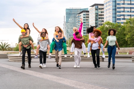 happy playful multiethnic group of young friends