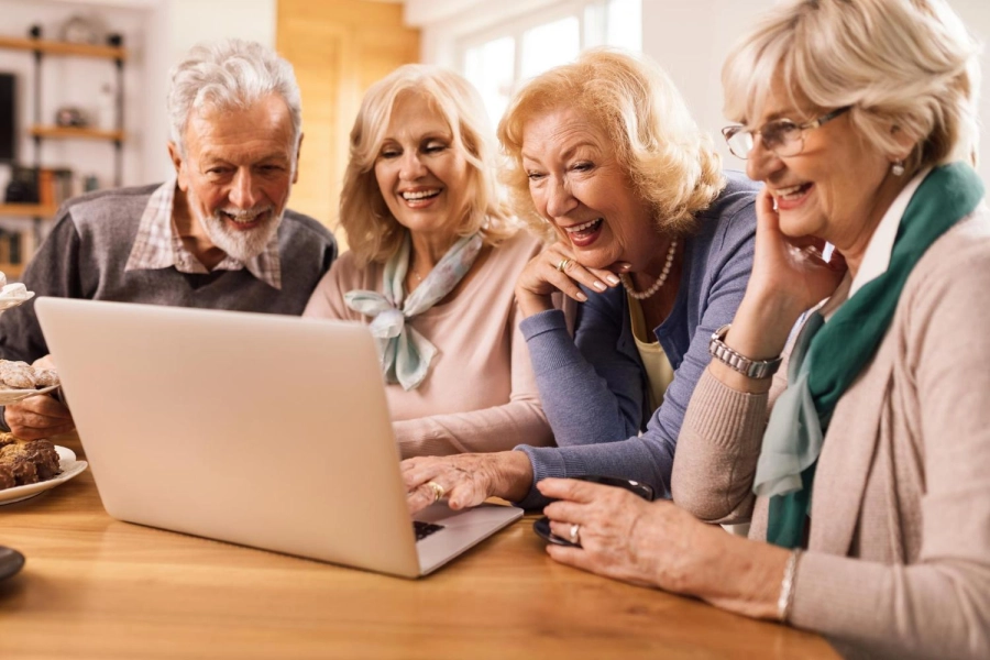 group-happy-mature-friends-having-fun-while-surfing-net-computer-home